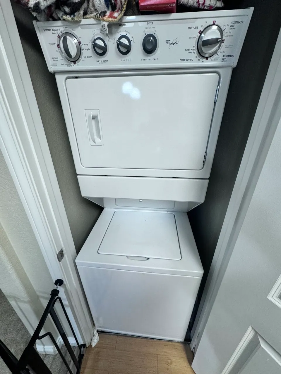 Stacked Whirlpool washer and dryer combo unit in closet