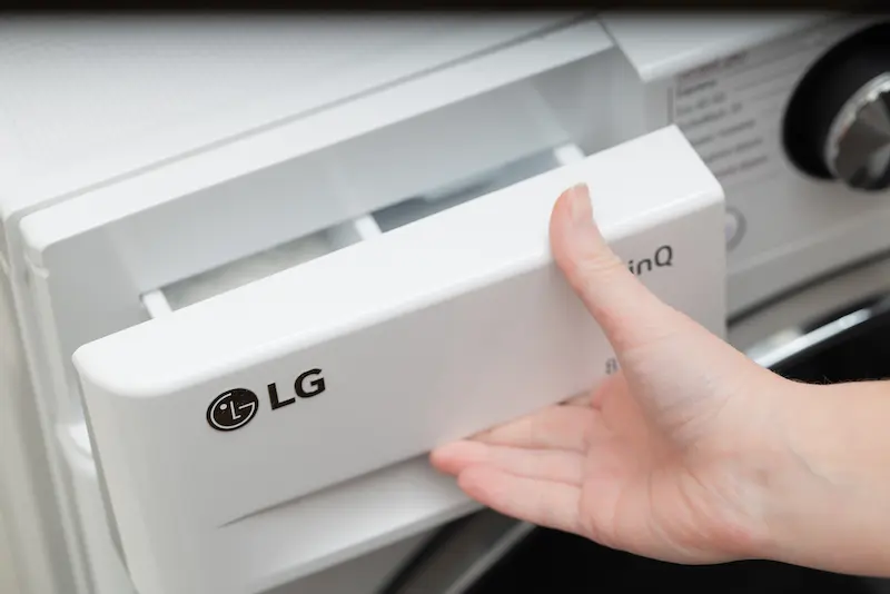 LG washer detergent drawer being opened for service inspection