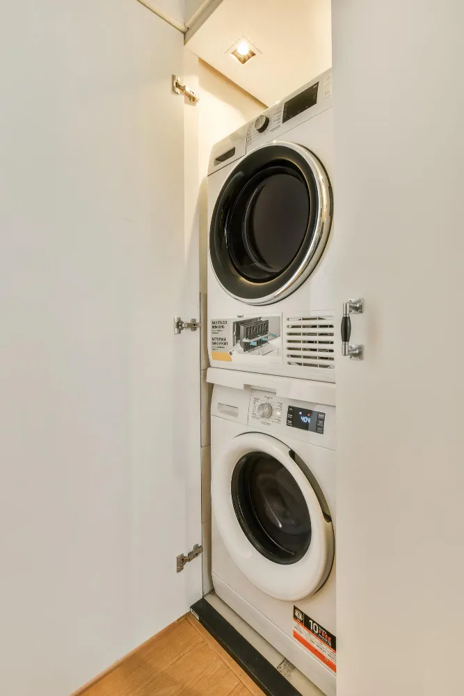Stacked washer and dryer installed inside closet cabinet