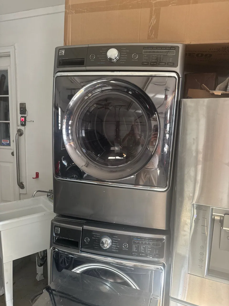 Stacked Kenmore washer and dryer unit in laundry room