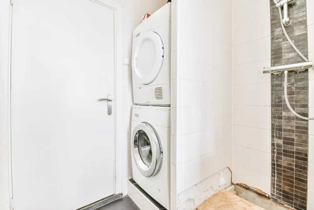 Compact stacked washer and dryer in small home laundry area