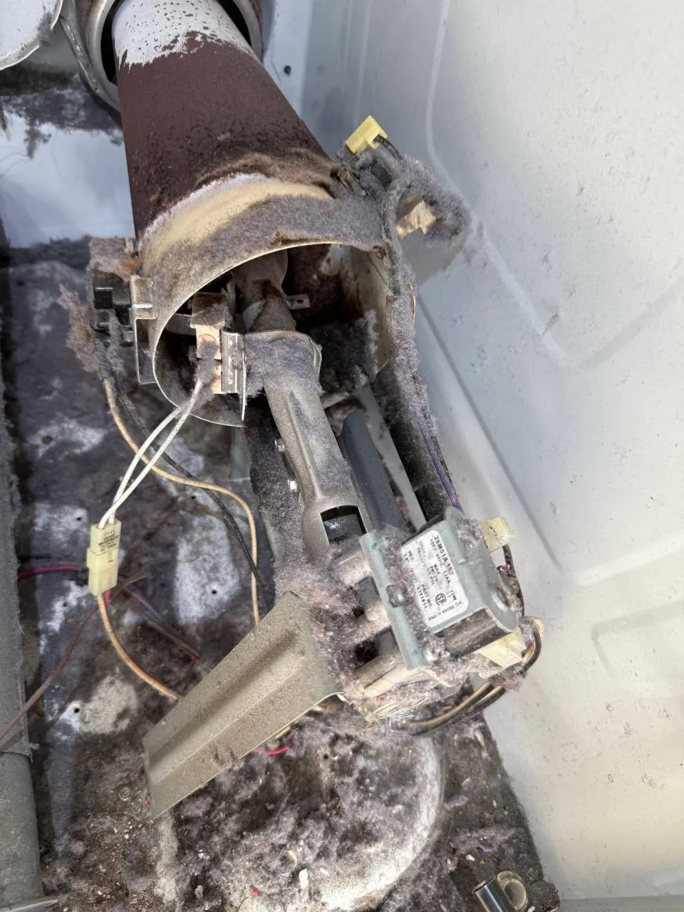 Dryer interior with heavy lint buildup around heating element