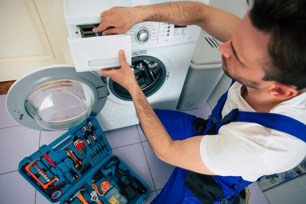 Technician repairing Insignia washing machine