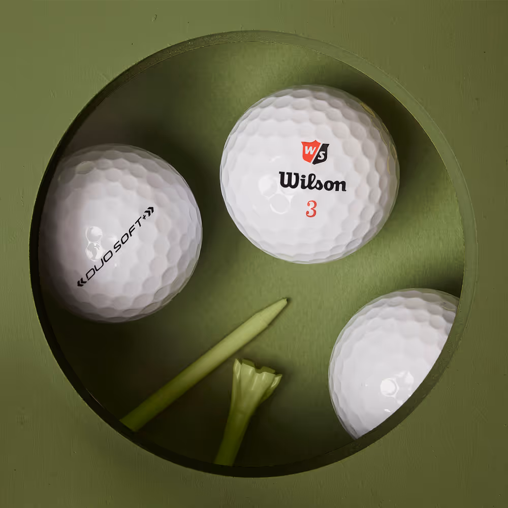 Golf balls with a CNC cut hole representing the hole, balls inside