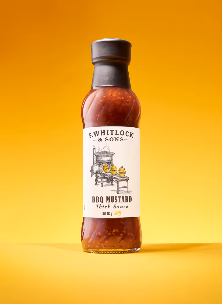 a red firey sauce tub against a yellow background