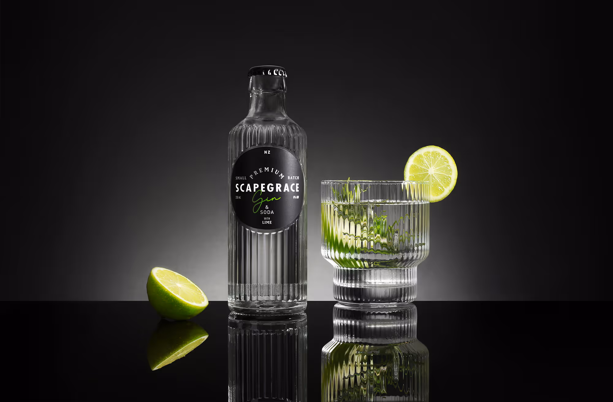Bottle of gin on  dark backroung with lime