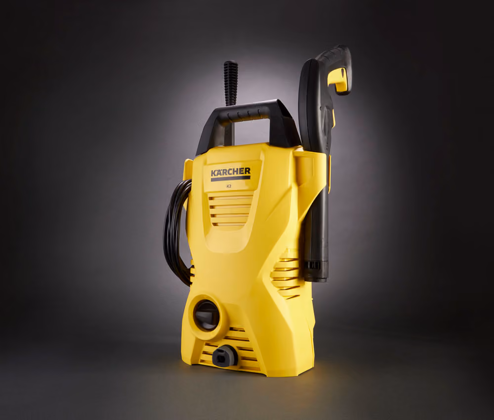 Auckland product photography of a Kärcher K2 pressure washer on a dark gradient background with dramatic studio lighting, by Amanda Hughes Photography.