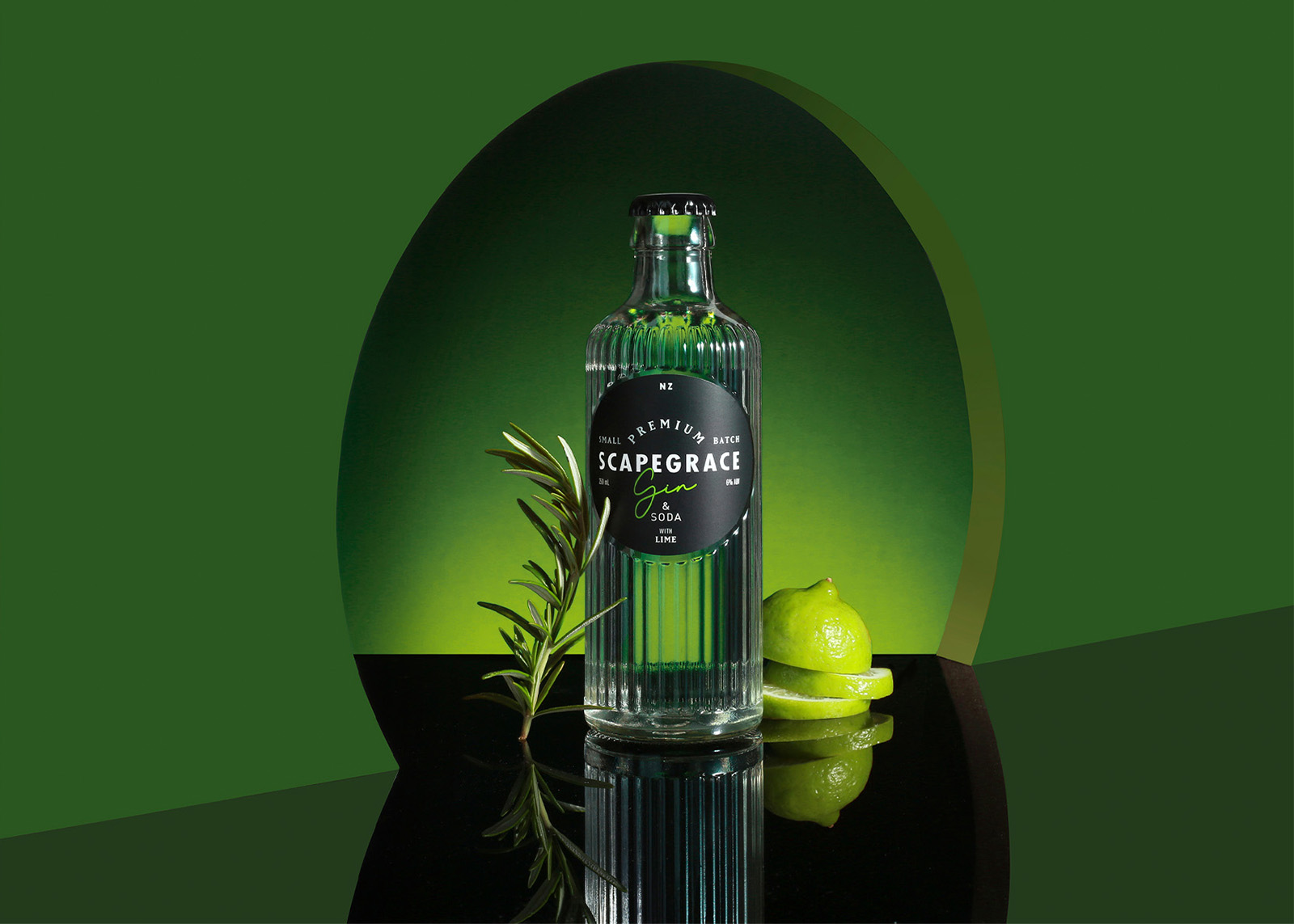 Scapegrace Gin & Soda bottle with lime slices and rosemary on reflective black surface and green background.