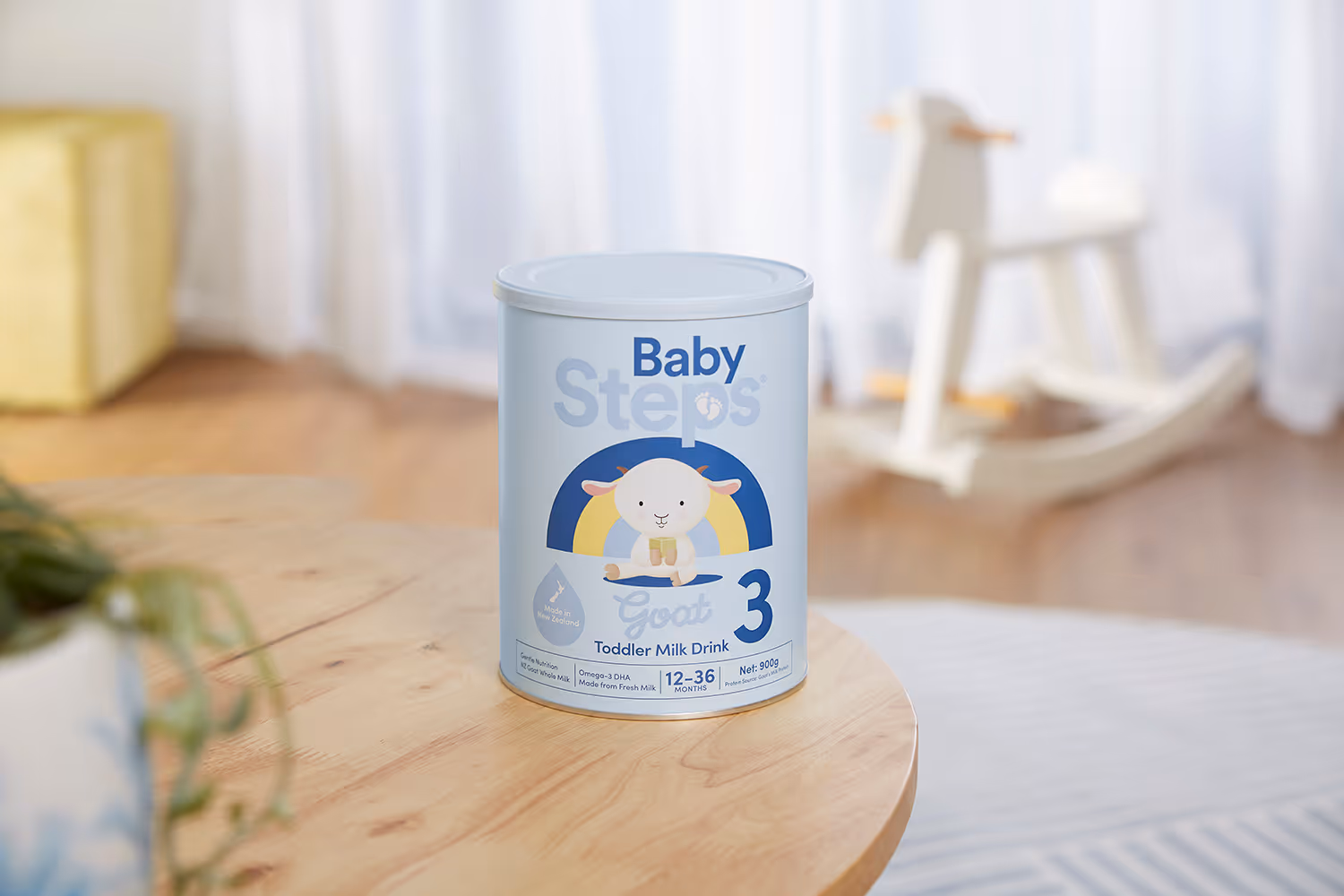 Auckland product photography of Baby Steps Goat Stage 3 Toddler Milk Drink sachets styled on a marble kitchen bench with fresh fruit, lunchboxes, and a wooden chopping board, by Amanda Hughes Photography.