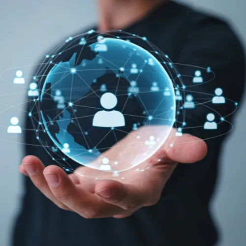 Hand holding a glowing digital globe with interconnected user icons representing a global network.