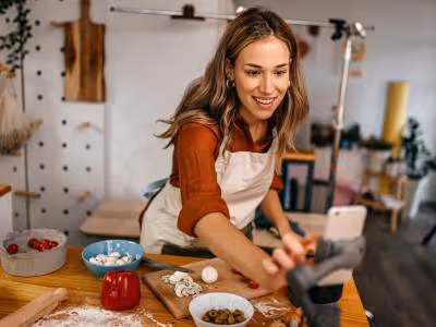 Female cook using her phone in the kitchen.