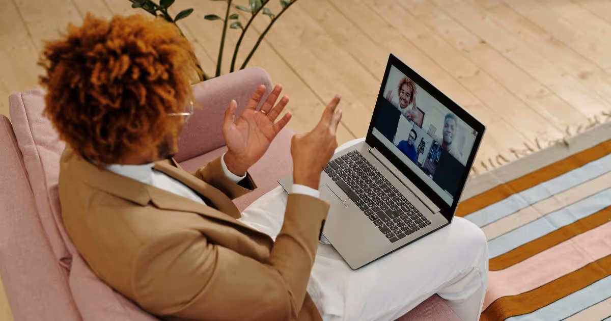 Man talking to group of people on a laptop.