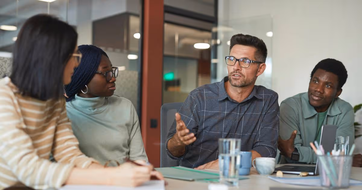 Group of colleagues discussing in a meeting.