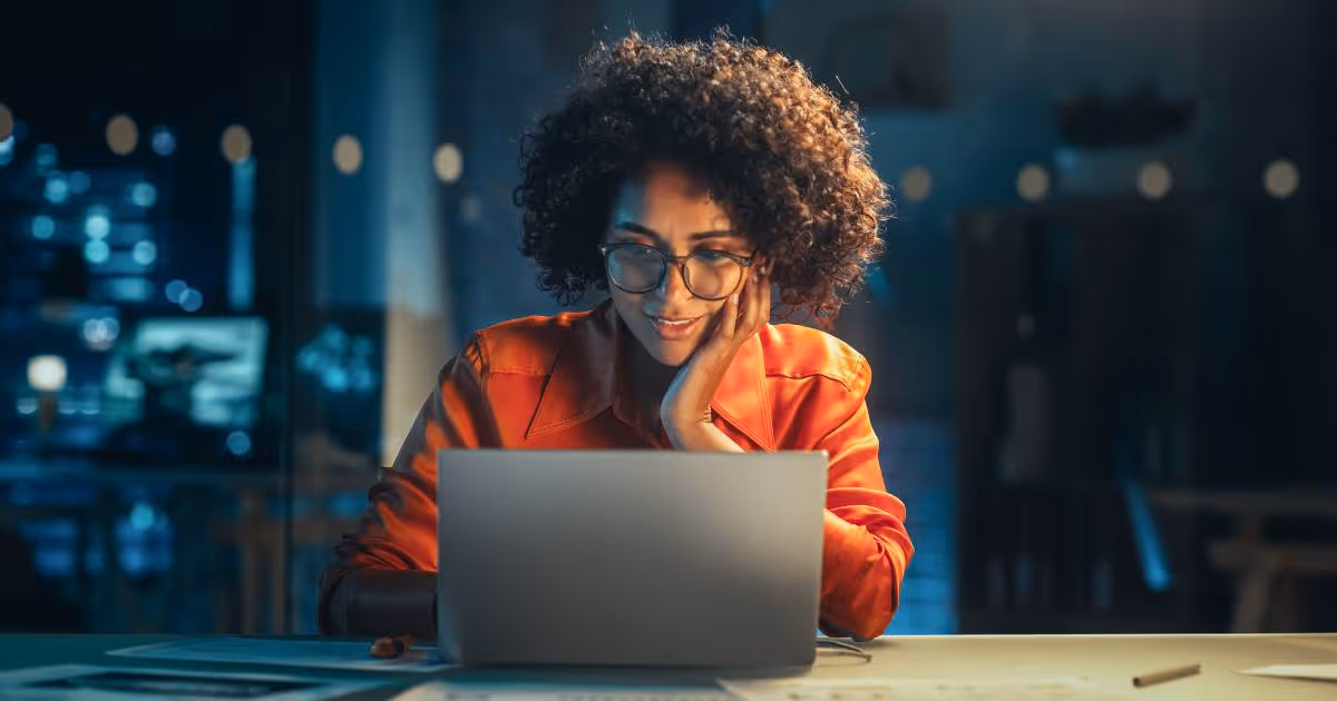 Girl infront of laptop working.