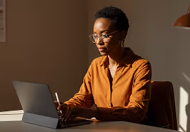 Woman working at laptop.