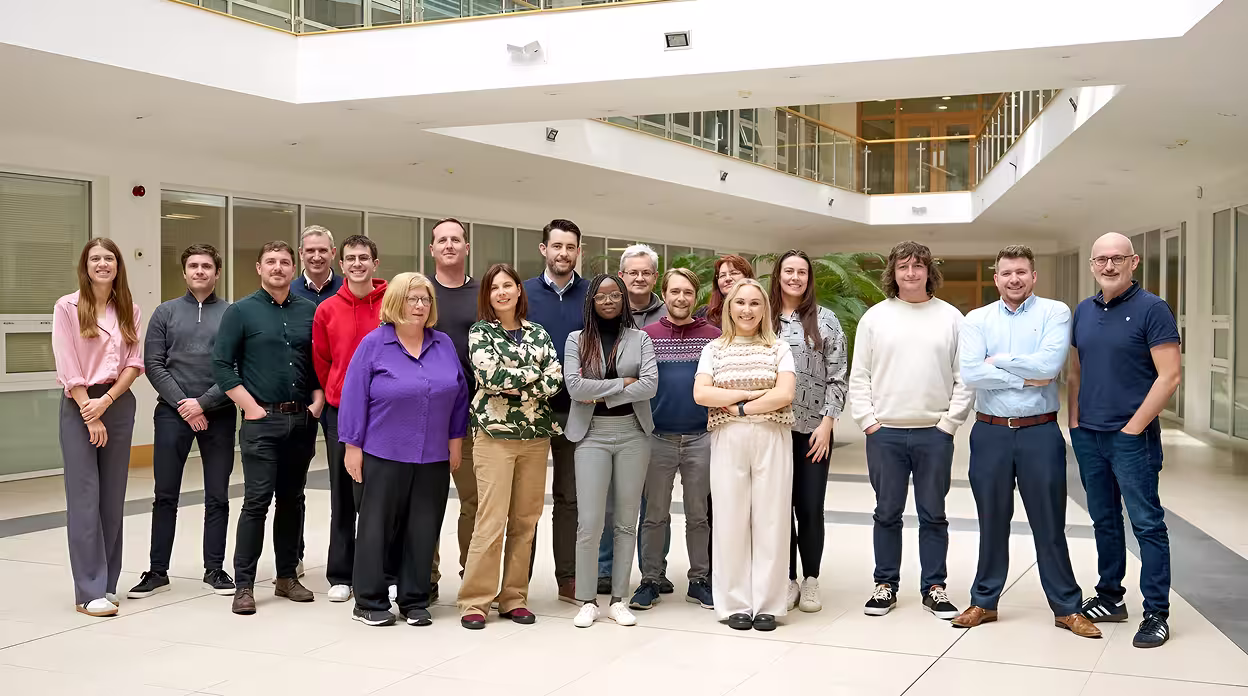 Team photo of Indeemo employees outside office.