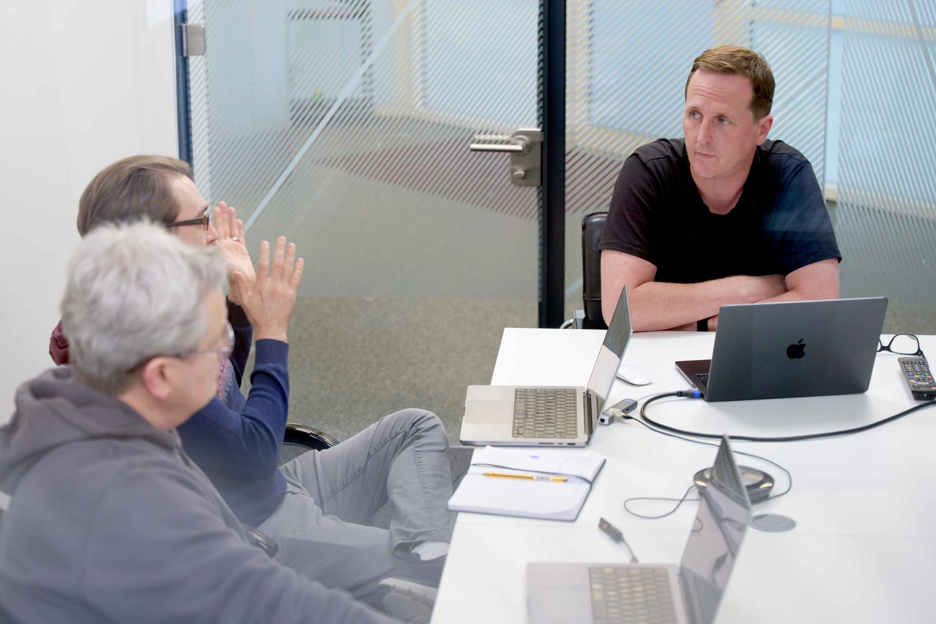 Indeemo team in a meeting room discussing at a table.