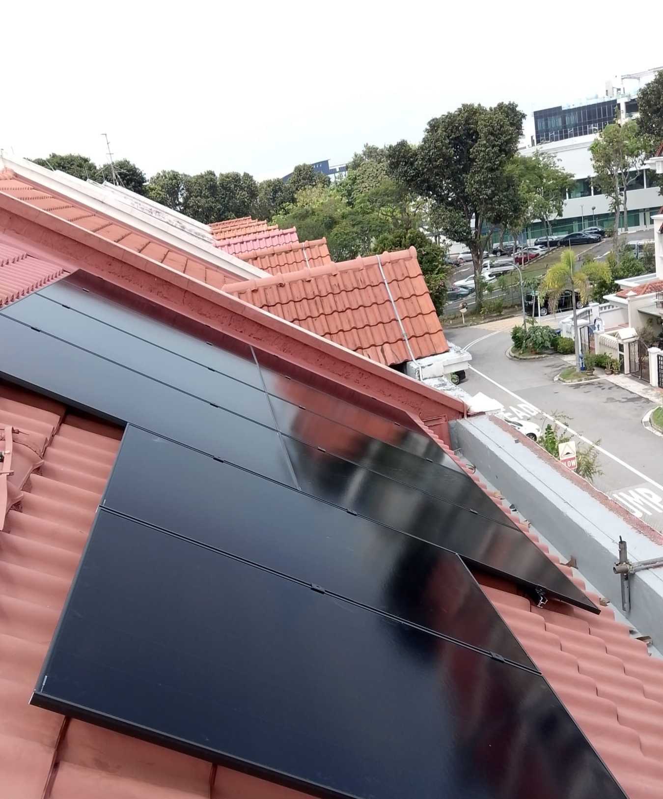 View of an 11.21 kWp solar panel array on a tile roof at a Singapore terrace house, showing the rows of panels a typical landed home needs