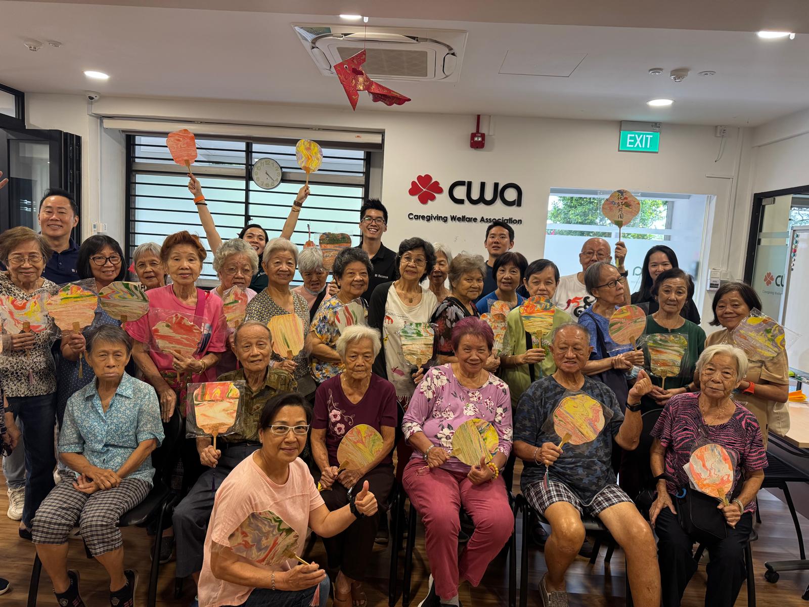 Rezeca Renewables volunteers with seniors during a games and crafts afternoon at the Caregiving Welfare Association, November 2025.