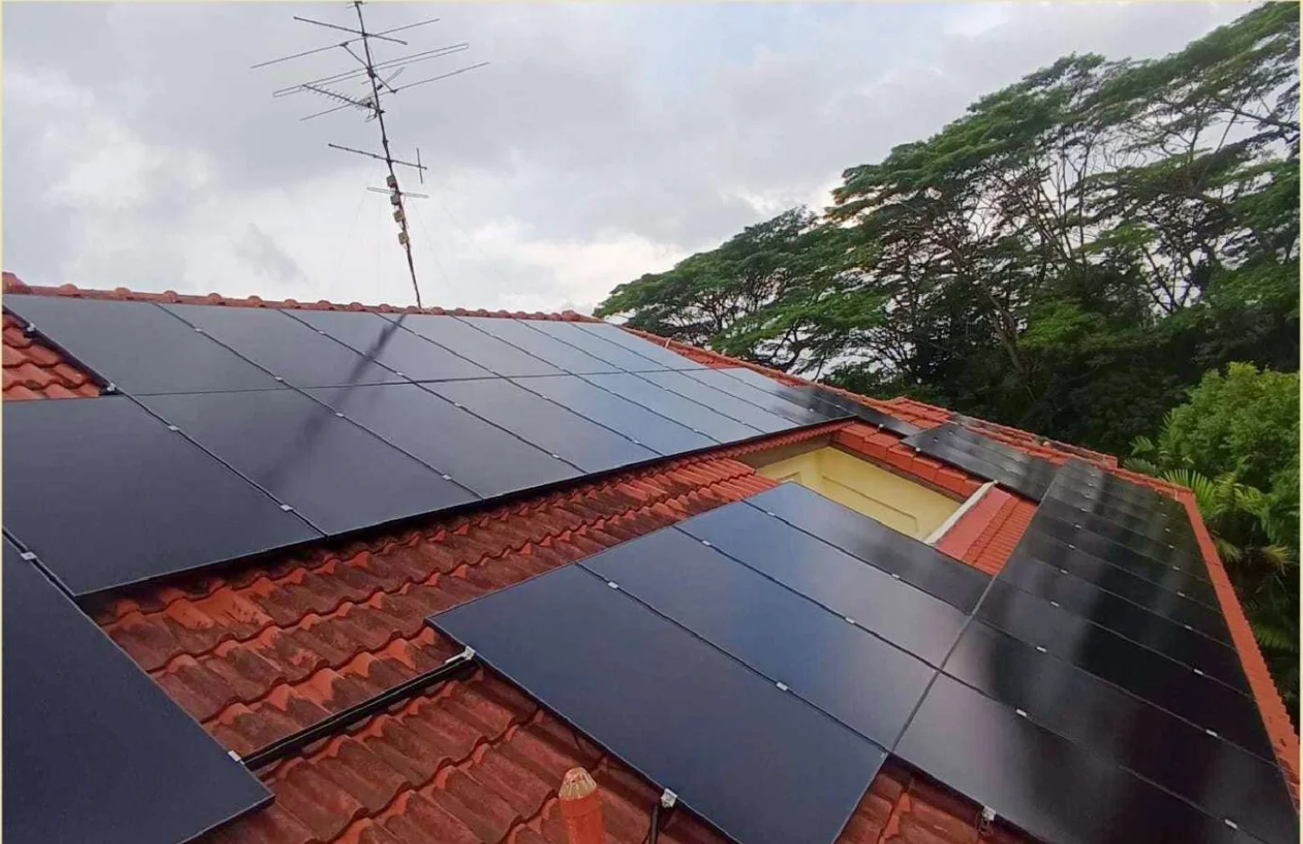 66.30 kWp solar system on a Good Class Bungalow in Upper Bukit Timah, District 21, Singapore. 130 Aiko 510 Wp full-black panels on a tile roof. Installed by Rezeca Renewables.