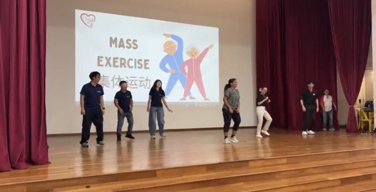 Rezeca Renewables volunteers joining the mass exercise on stage at CWA's Caregiver Engagement Day 2026 in Singapore.