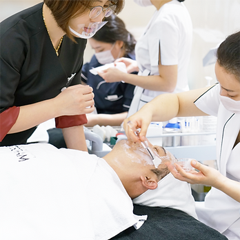 Participants practicing a skincare treatment during a Cosgram class