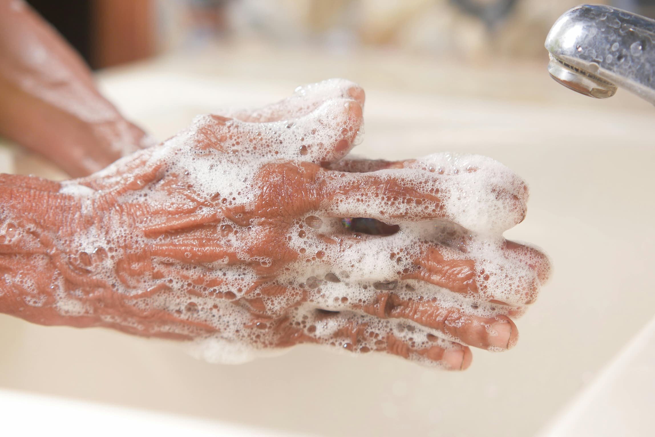 Person washing hands excessively due to contamination OCD fears