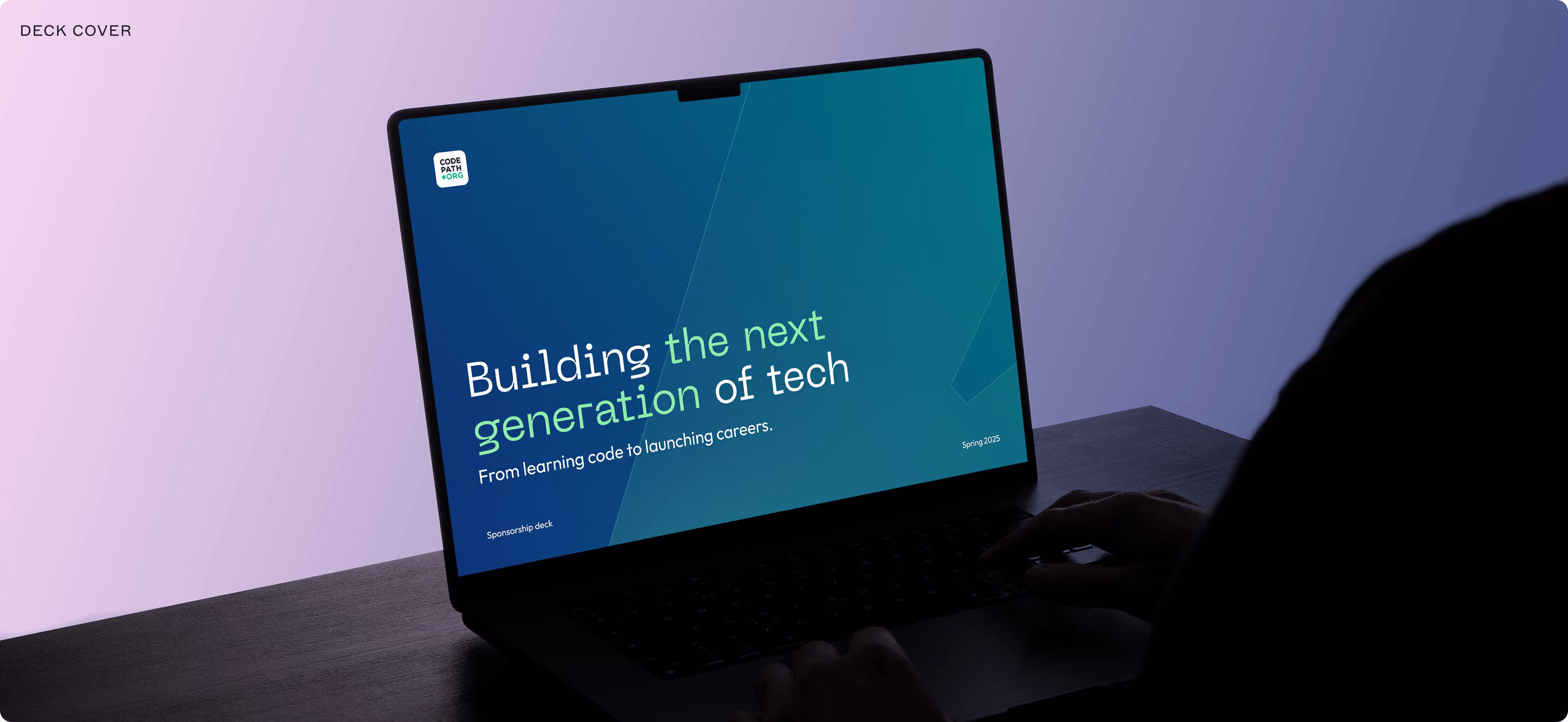Person using a laptop displaying a slide titled 'Building the next generation of tech' with a subheading 'From learning code to launching careers.'