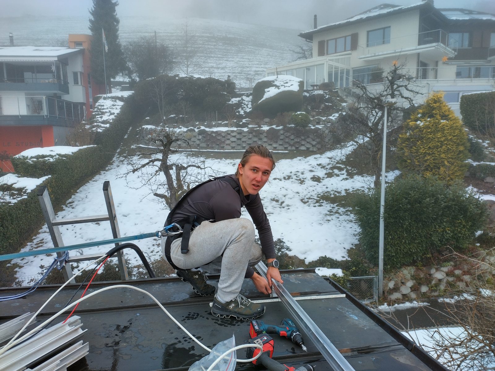 Der Bauherr montiert die Schienen der Solaranlage auf dem Blechfalzdach in Oberhofen