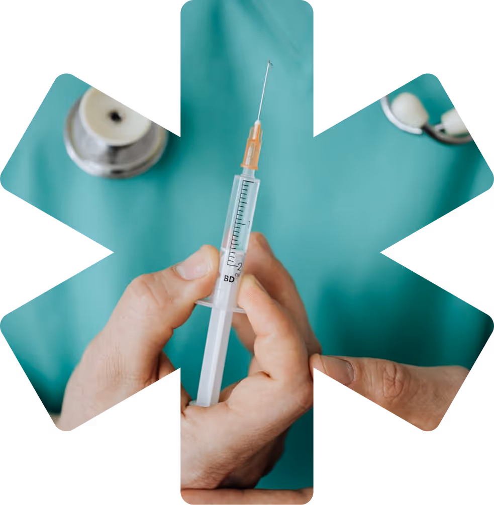 A person is holding a needle in front of a medical symbol.