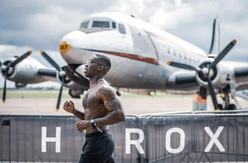 Running laps move outdoors at some events — environment varies by location.