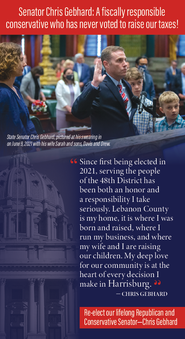 State Senator Chris Gebhard raising his right hand at his swearing-in on June 9, 2021, with his wife Sarah and sons Davis and Drew standing beside him in a formal setting.