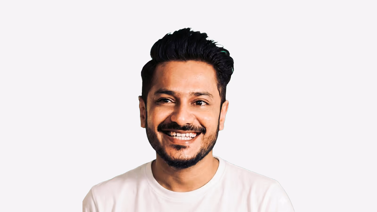 Smiling Muhammad Salman with dark hair and beard wearing a white shirt against a green gradient background.