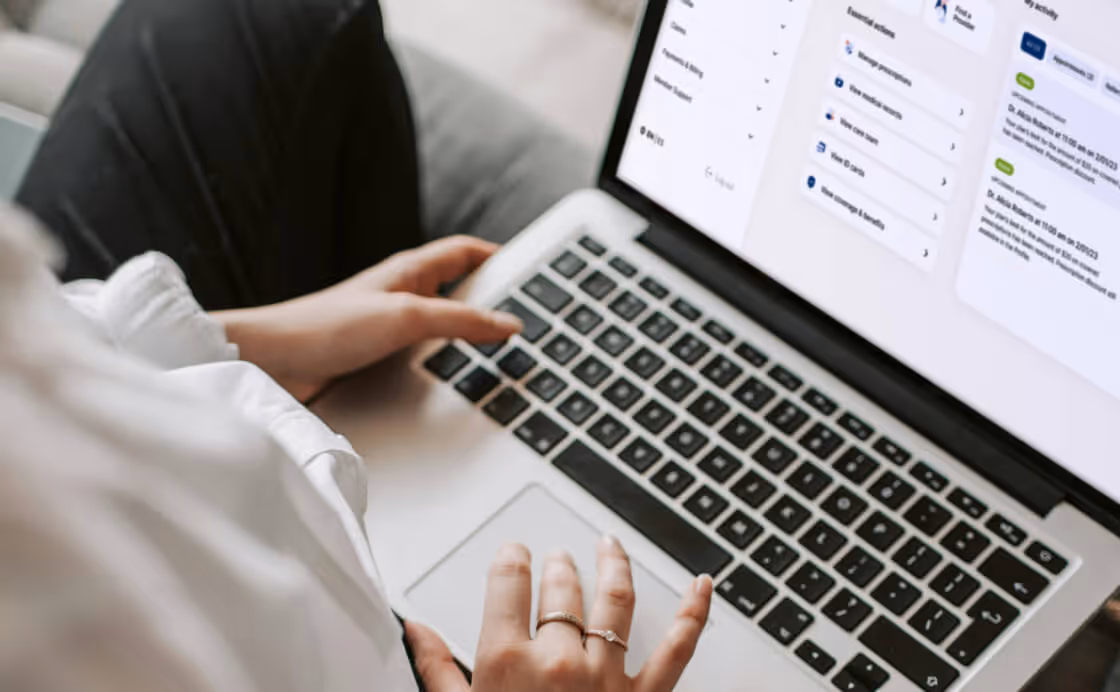 Person using a laptop with a dashboard screen showing various task and event updates.