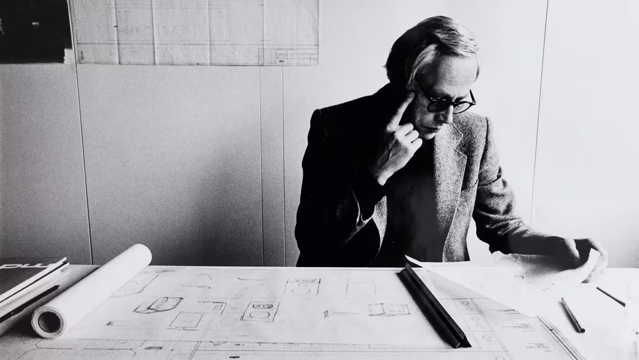 Photo of Dieter Rams working in deep thought at Braun in 1970.