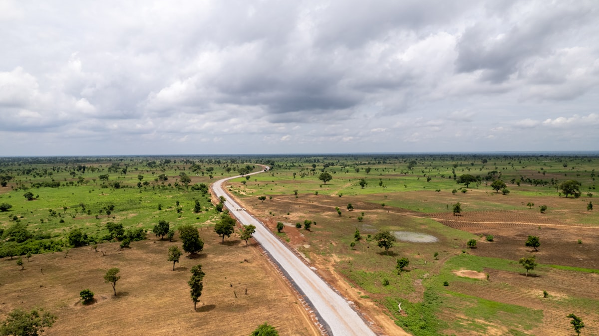 Aerial view of road cutting through green landscape in Nigeria showing land development potential
