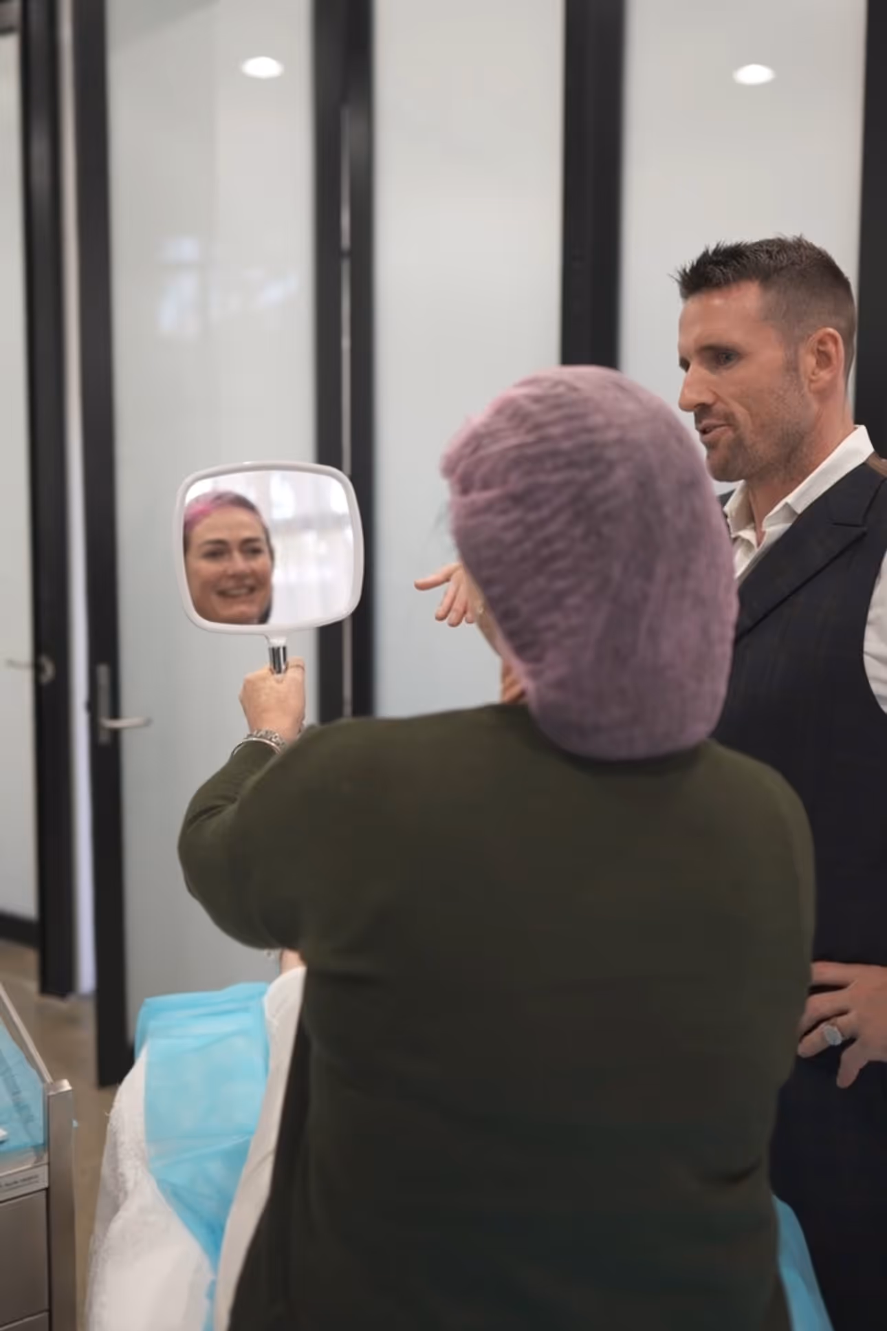 Client looking in mirror with Dr Jonathan Hopkirk