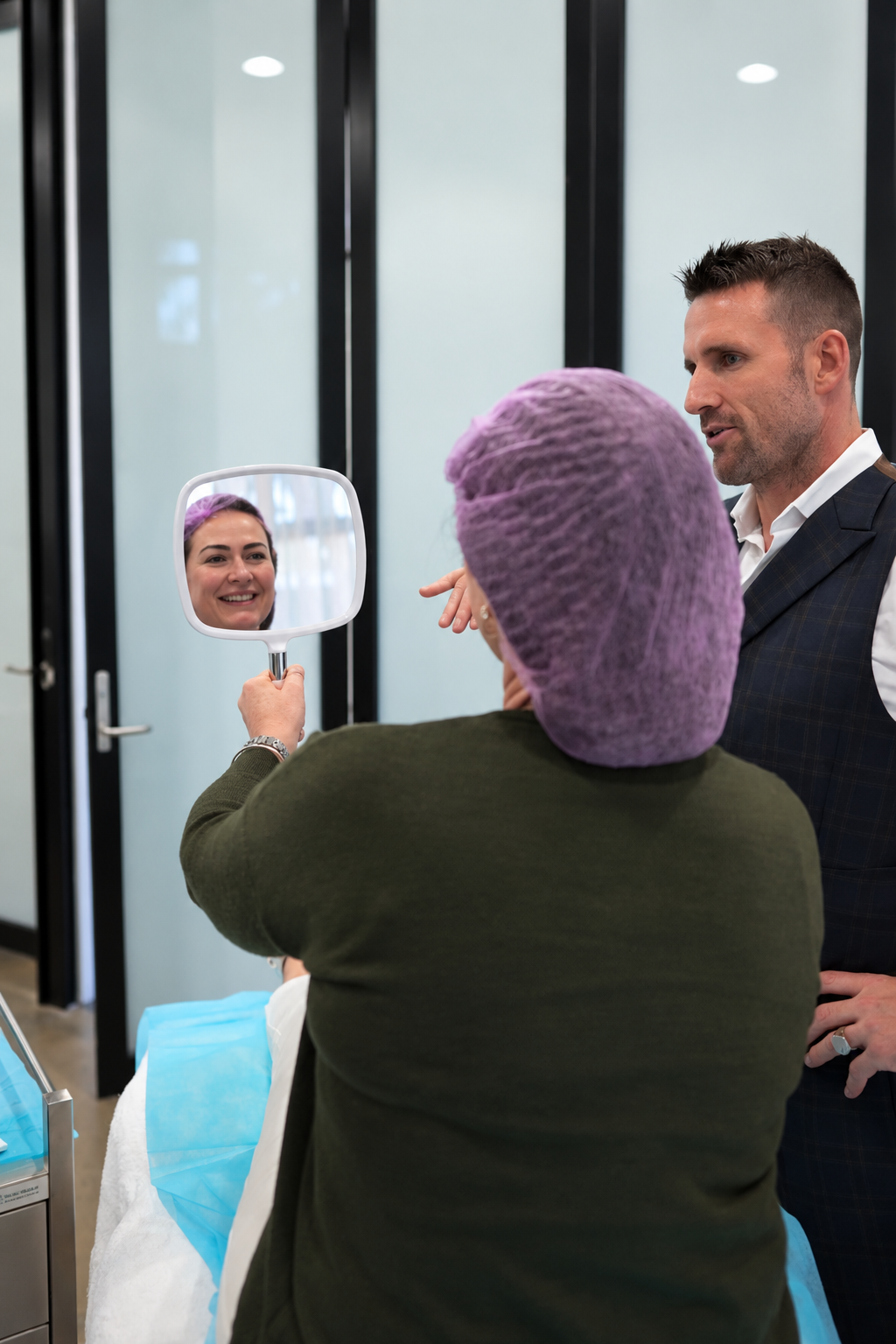 Client looking in mirror with Dr Jonathan Hopkirk