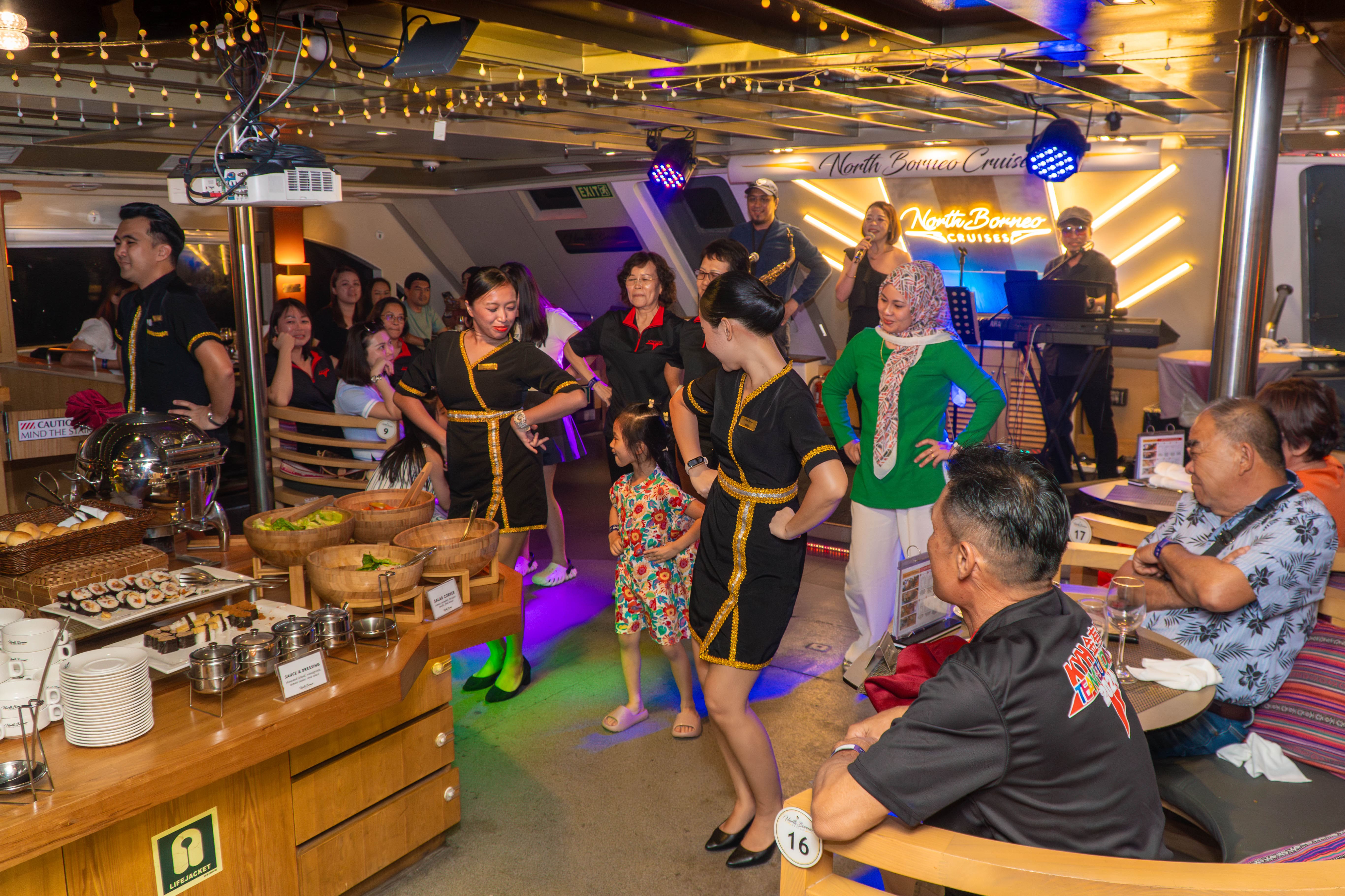 NBC crew dancing with guests with live band at the background.