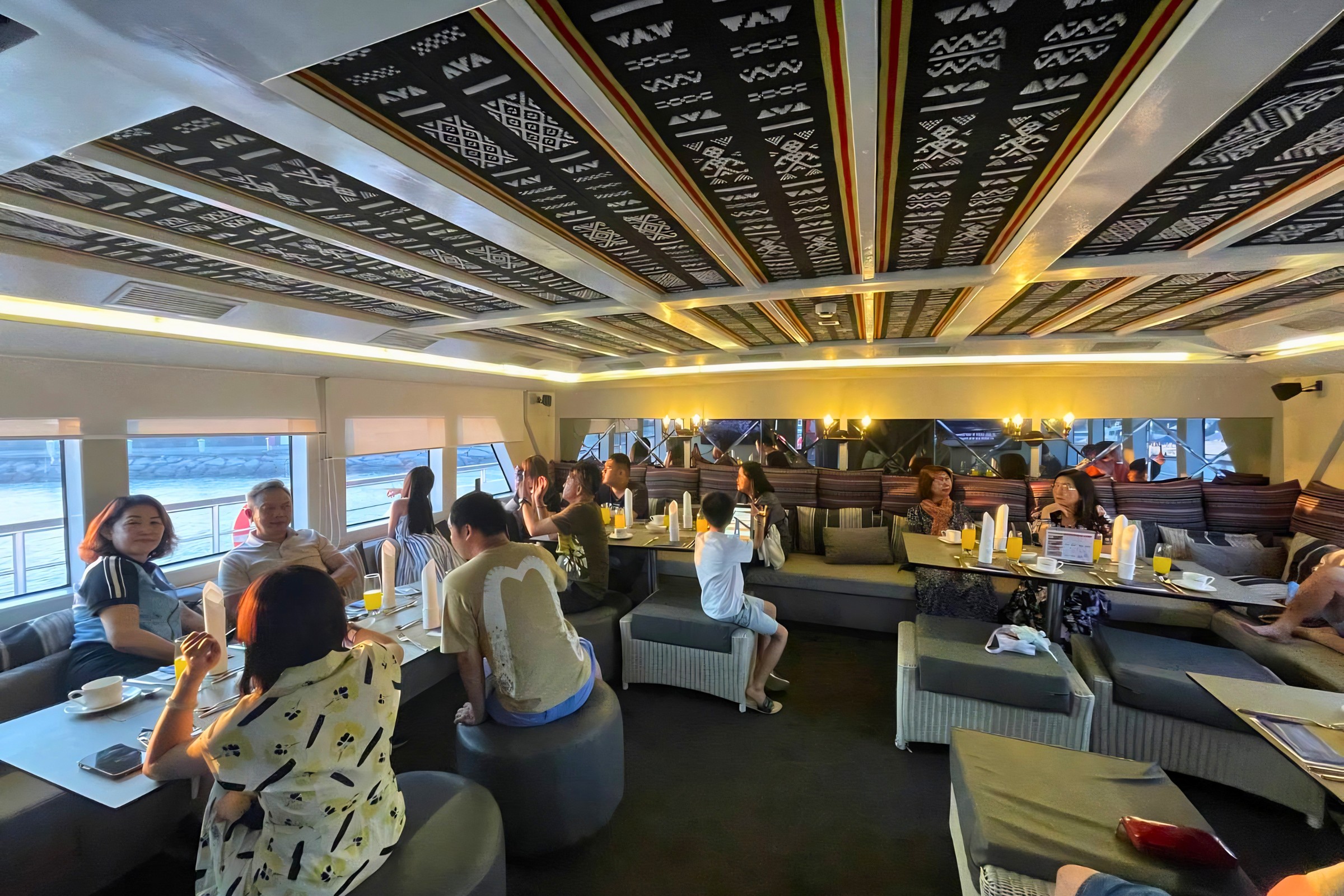Group of people enjoying dining inside vip room on North Borneo Cruises.