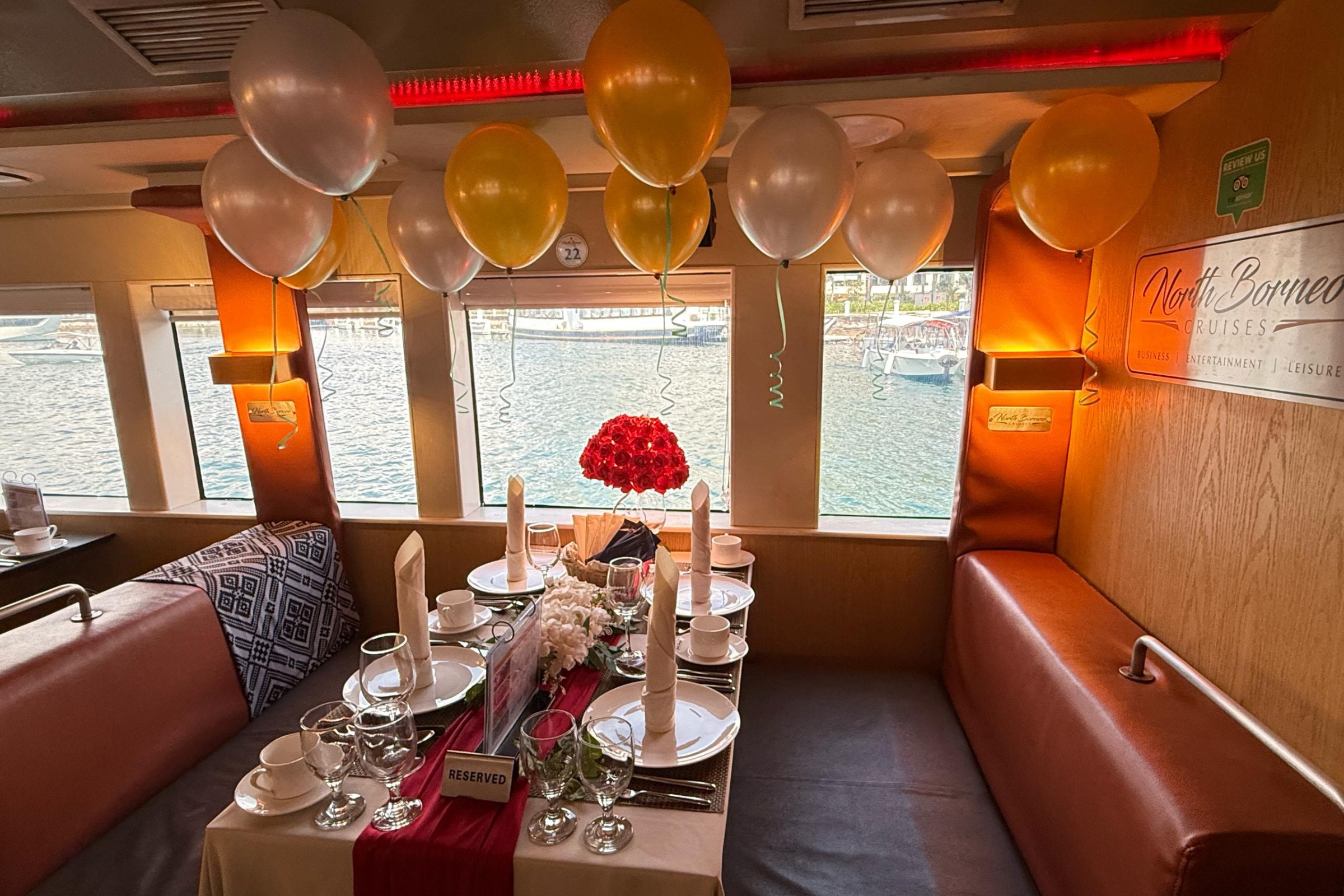 Reserved window dining table for celebration inside North Borneo Cruise.