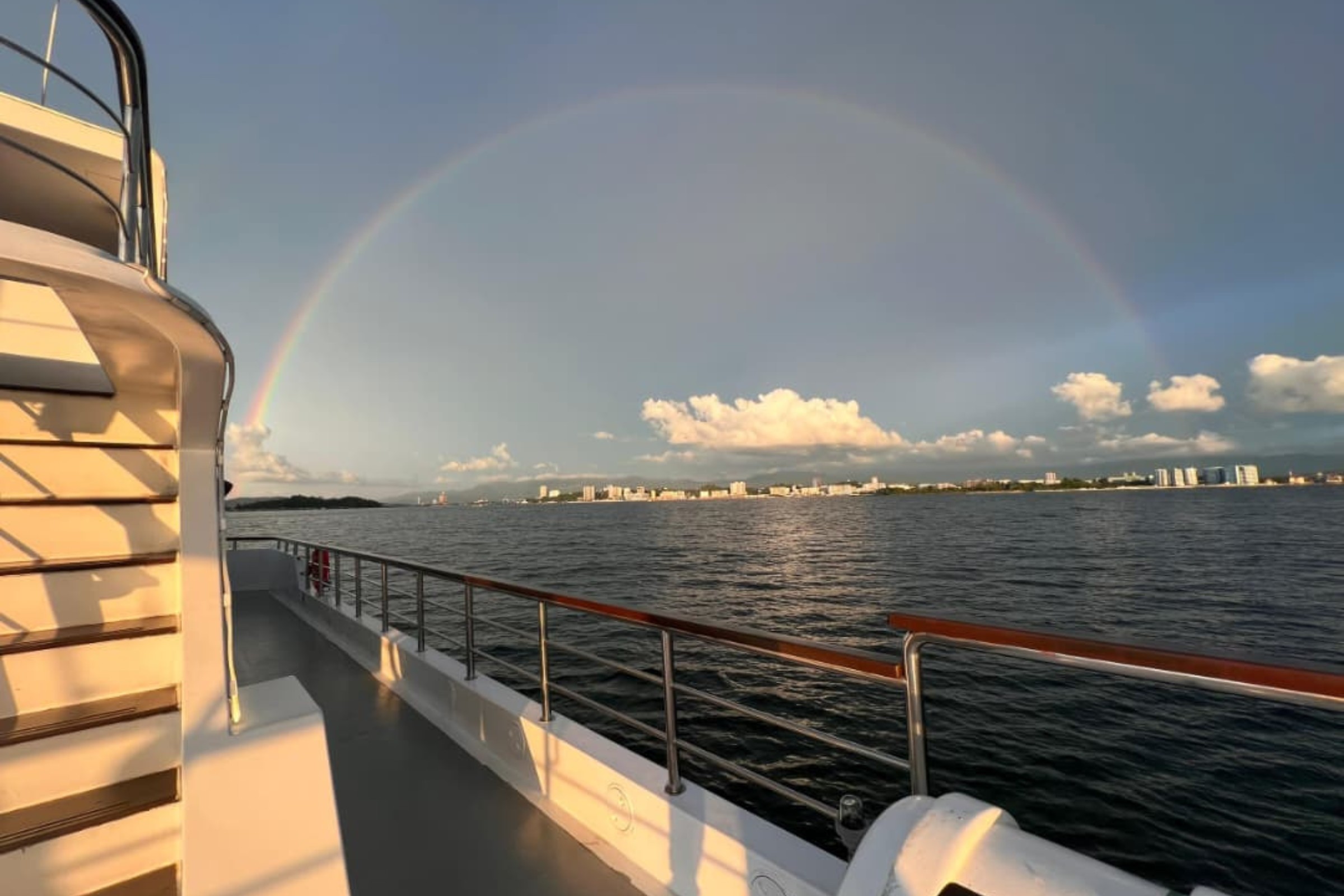 View from deck showing a rainbow over Kota Kinabalu city.