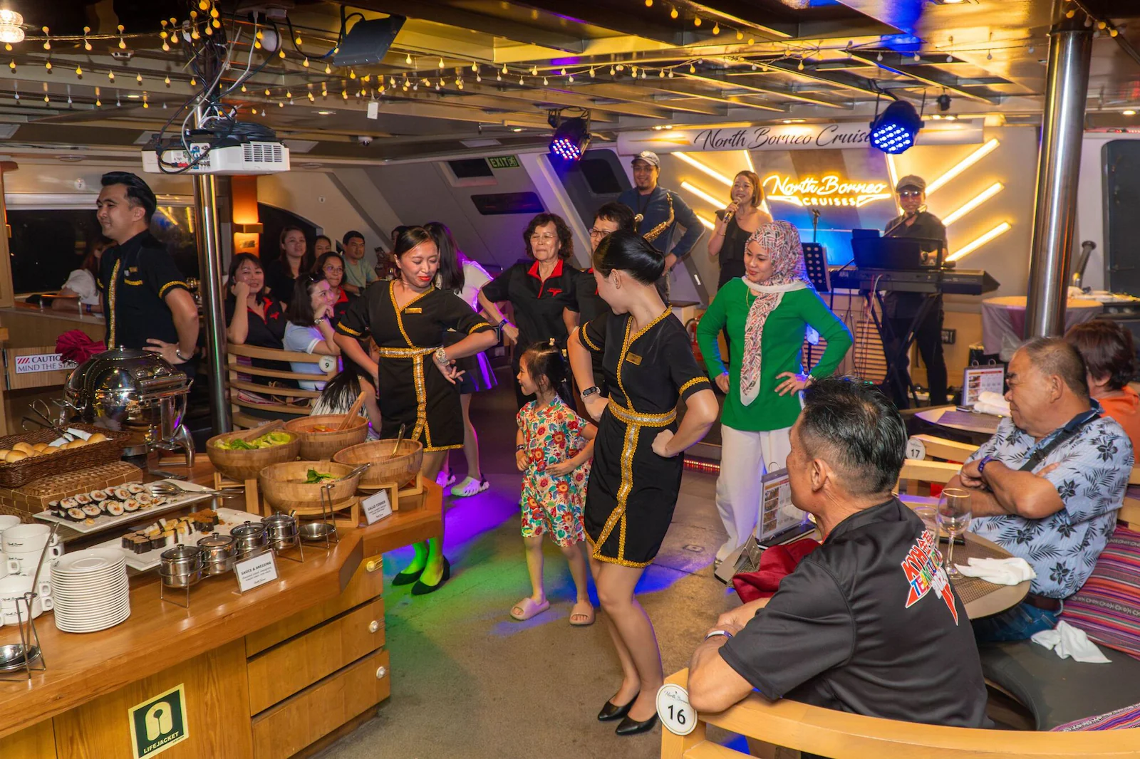NBC crew dancing with guests with live band at the background.