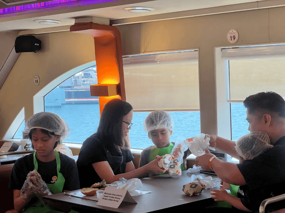 Children burger making with parents onboard