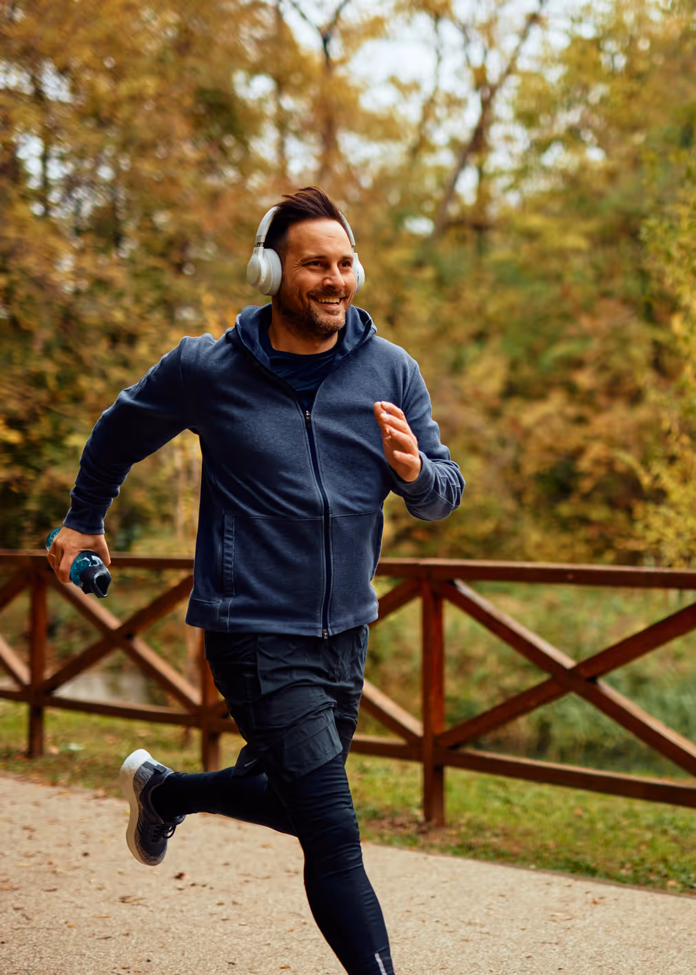 A man enjoys a refreshing jog along a scenic park trail