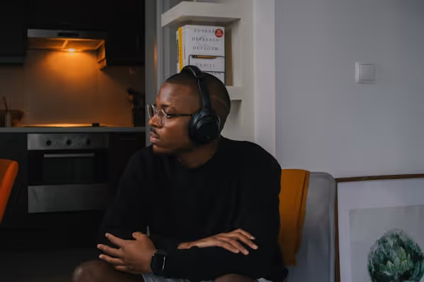 a man sitting in a chair wearing headphones