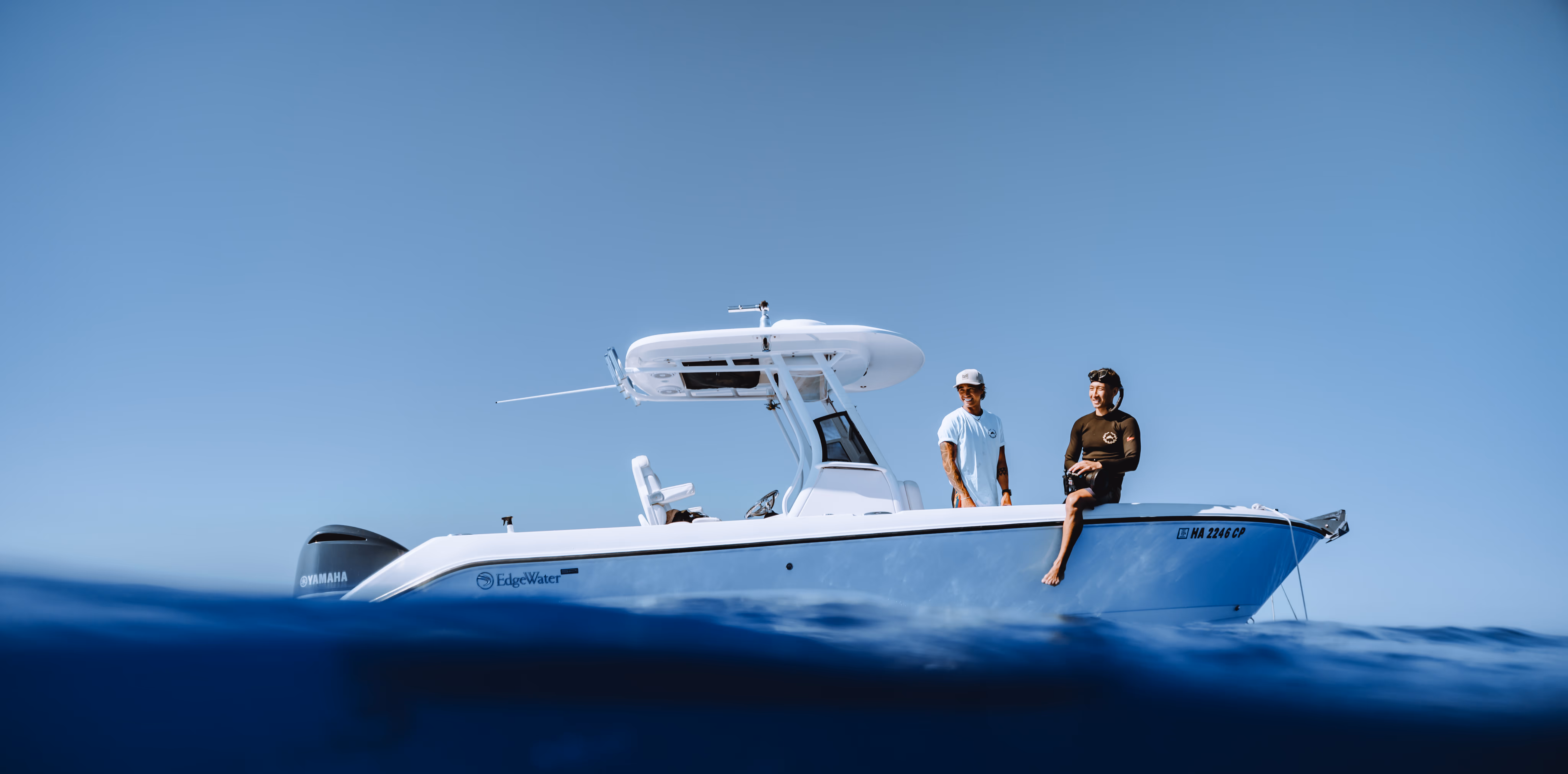 Water point of view shot of captain and water guide observing calm blue waters from the boat.