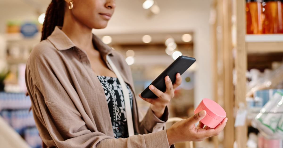 woman taking photo of product in store