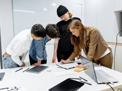 Research team at laptop during a design thinking workshop.