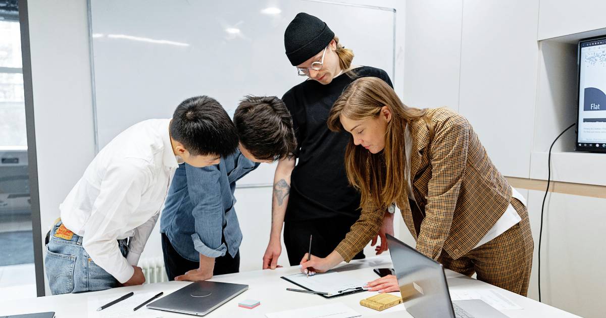 Research team at laptop during a design thinking workshop.